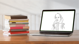 Schreibtisch mit Bücherstapel, daneben Shakespeare Portraitzeichnung auf Laptop